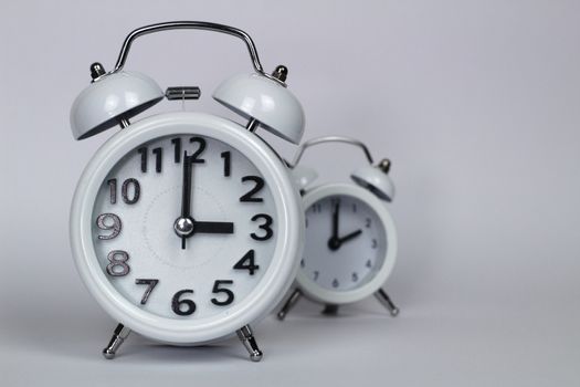 Clock marking winter time change in autumn white background