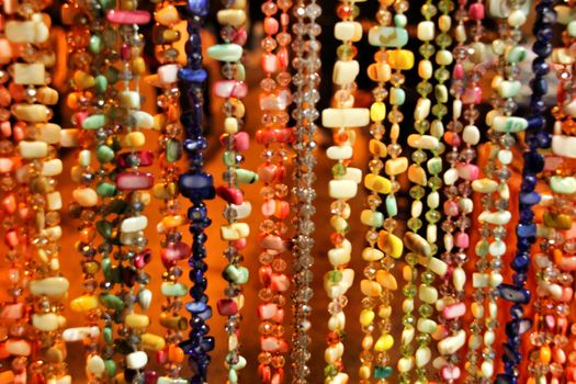 Beautiful and colorful rhinestones necklaces hanging in a street stall