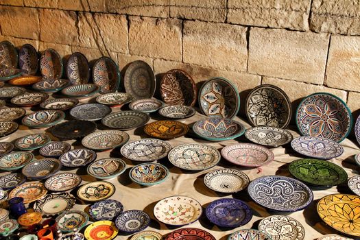 Beautiful and colorful ceramic plates for sale at a medieval market stall