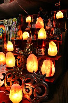 Beautiful colored glass lamps for sale hanging at a stand in the Medieval Market of Elche