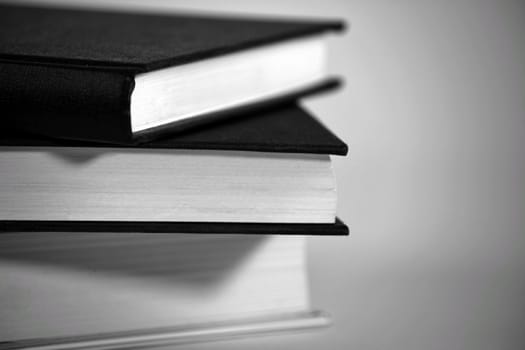 Black and white books stacked on white background