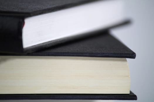 Black and white books stacked on white background