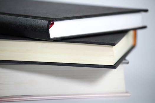 Black and white books stacked on white background