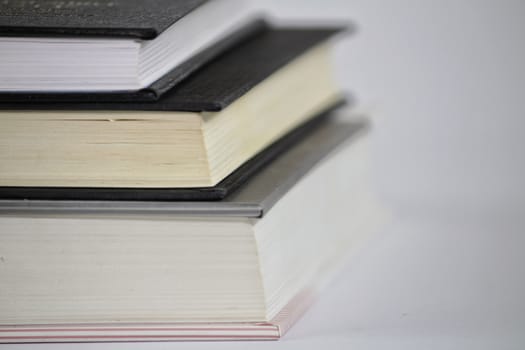 Black and white books stacked on white background