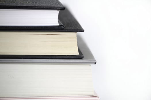 Black and white books stacked on white background