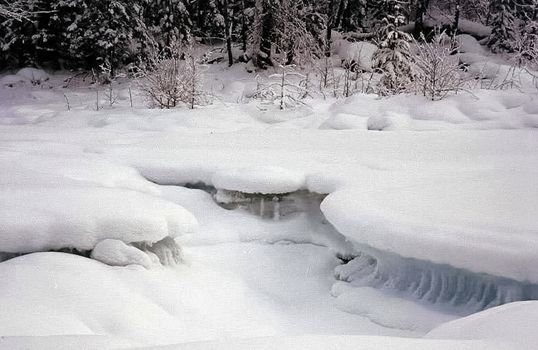Ice and snow on the river. Melting snow in the spring on the reservoir.