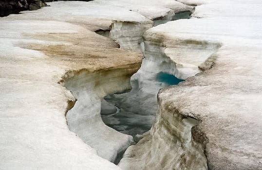 Ice and snow on the river. Melting snow in the spring on the reservoir.