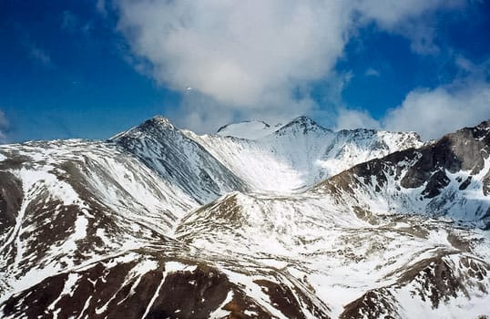 Mount Sayan in winter in the snow. The nature of the mountains is sayan.