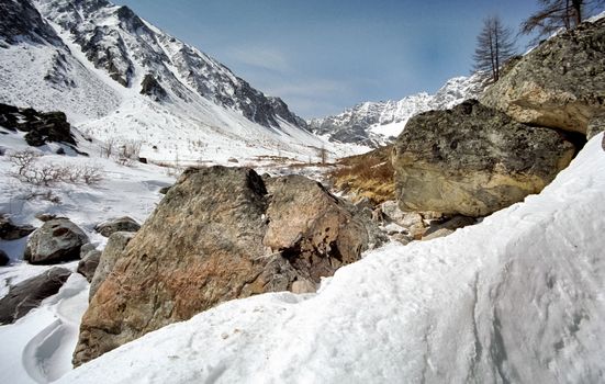 Mount Sayan in winter in the snow. The nature of the mountains is sayan.