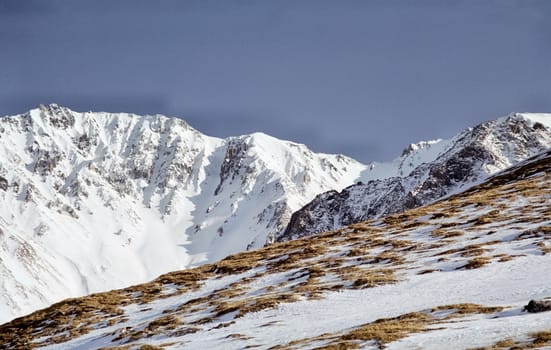 Mount Sayan in winter in the snow. The nature of the mountains is sayan.