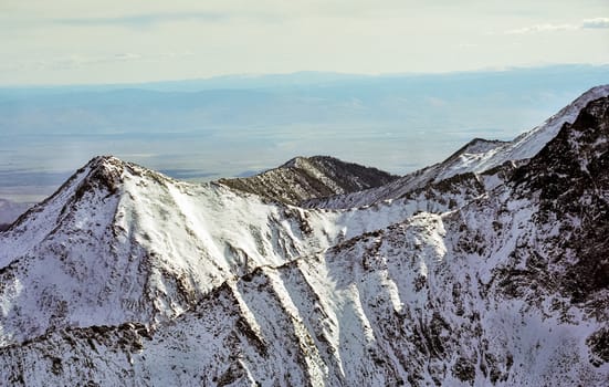 Mount Sayan in winter in the snow. The nature of the mountains is sayan.