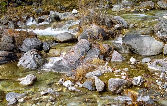 Mountain river. Stones and water of a mountain river. The mountains are said.