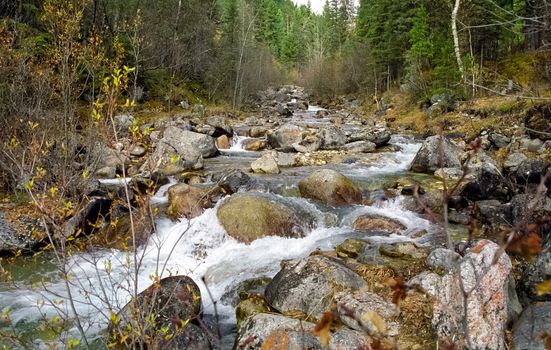 Mountain river. Stones and water of a mountain river. The mountains are said.