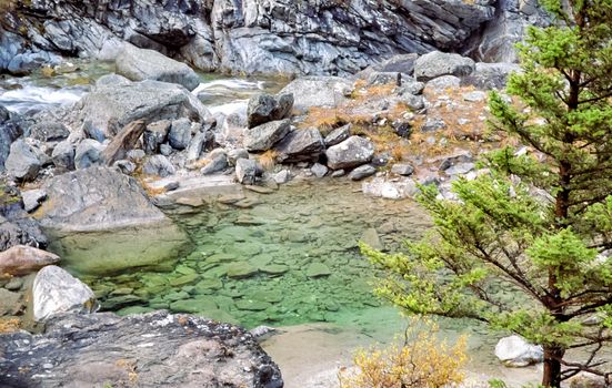 Mountain river. Stones and water of a mountain river. The mountains are said.