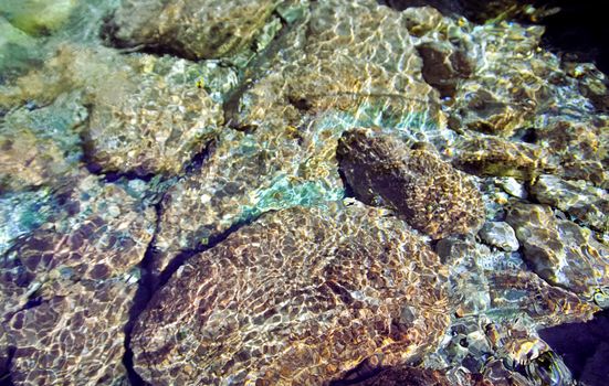 Mountain river. Stones and water of a mountain river. The mountains are said.