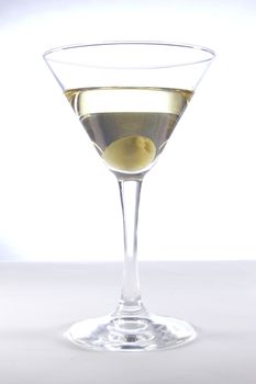 Glass with martini and olive on a white background