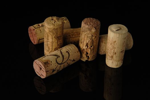 Tashkent, Uzbekistan - October 6, 2009 : Heap of old wine corks on black background with reflection. Studio photography