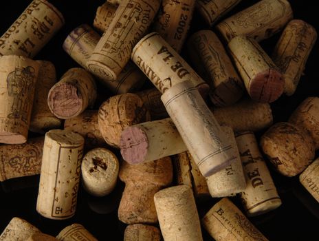 Tashkent, Uzbekistan - October 6, 2009 : Heap of old wine corks on black background. Studio photography