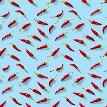 Red hot chilli seamless peppers pattern. Seamless pattern made of red chili or chilli on blue background. Minimal food pattern. Food background.