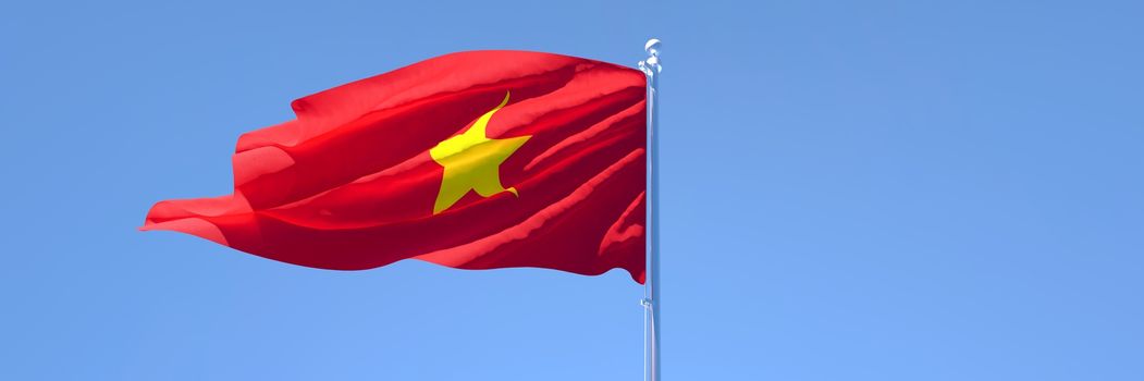 3D rendering of the national flag of Vietnam waving in the wind against a blue sky