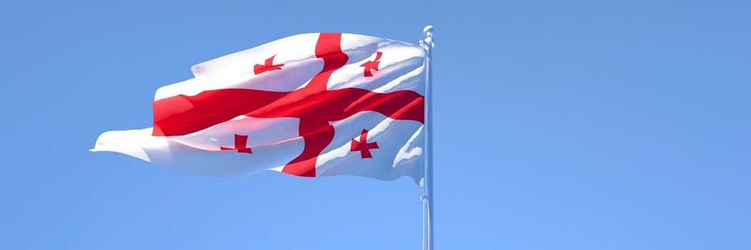 3D rendering of the national flag of Georgia waving in the wind against a blue sky