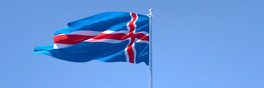 3D rendering of the national flag of Iceland waving in the wind against a blue sky