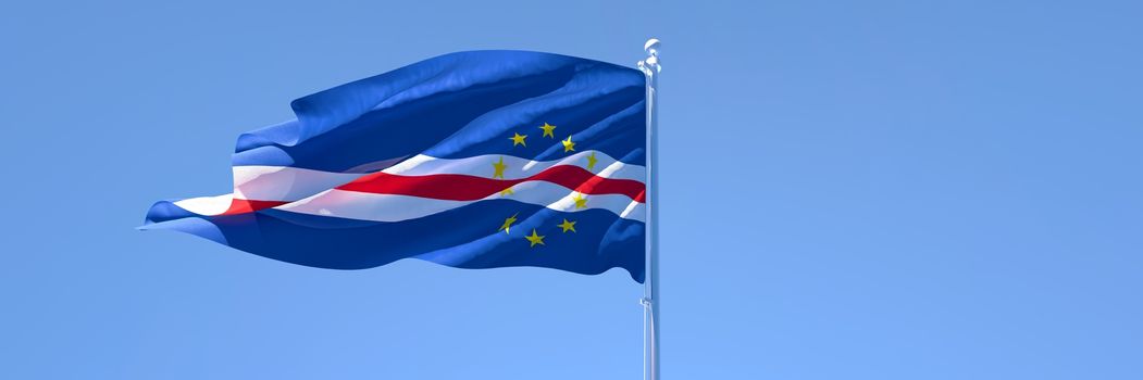 3D rendering of the national flag of Cape Verde waving in the wind against a blue sky