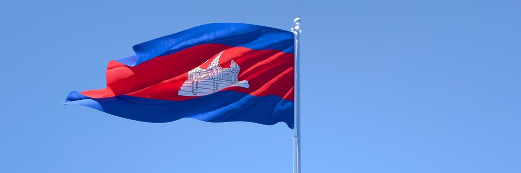 3D rendering of the national flag of Cambodia waving in the wind against a blue sky