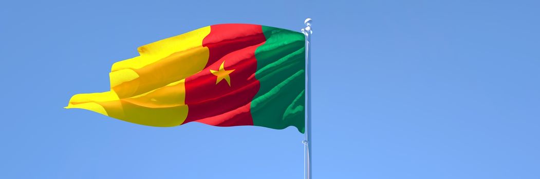 3D rendering of the national flag of Cameroon waving in the wind against a blue sky