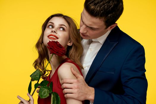 Couple in love man and woman with red rose classic costume red dress model. High quality photo