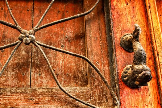 Old wooden door with bronze knocker