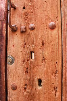 Old wooden door with wrought iron details in Villanueva de Los Infantes village, Spain