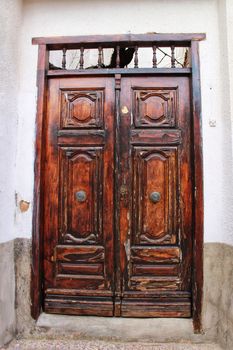 Old colorful carved wooden door in a small village in Castilla La Mancha community, Spain