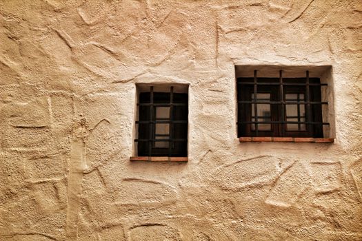 Small latticed windows on white wall in Altea, Spain