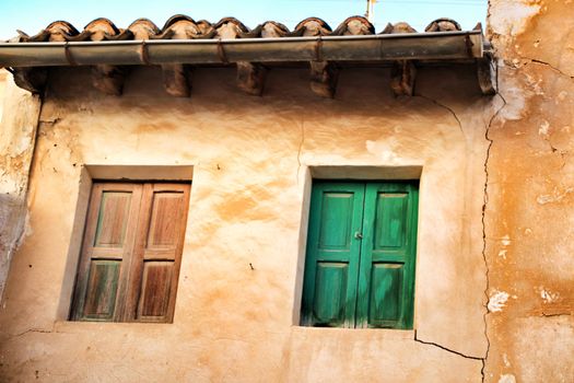 Old facade of old house with green window in Spain