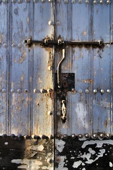 Old wooden door with wrought iron details in Cordoba, Spain