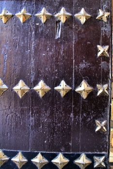 Old wooden door with wrought iron details in Cordoba, Spain