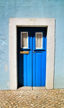 Old and colorful wooden door with iron details in Lisbon, Portugal
