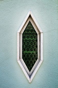 Beautiful Old and colorful wooden door with iron details and diamond shaped window in Lisbon, Portugal