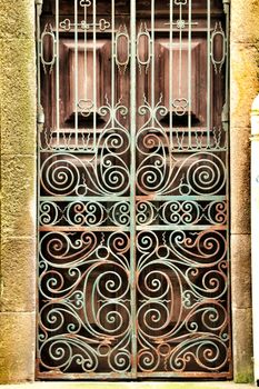 Old wooden green door with wrought iron fence in Porto, Portugal