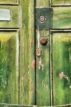 Old wooden green door with wrought iron details in Porto, Portugal