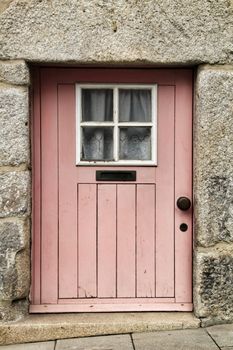 Old and small colorful wooden door with iron details in Porto, Portugal