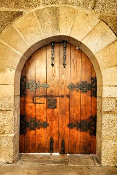 Old wooden door with wrought iron details in Porto, Portugal