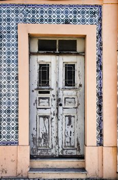Old wooden white door with wrought iron fence in Porto, Portugal