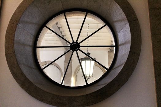 Circular vintage stone window with glass in Portugal