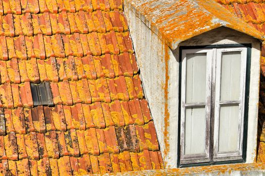 Old colorful and typical orange tiled roof in Lisbon, Portugal.