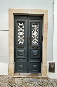 Old and colorful wooden door with iron details in Lisbon, Portugal