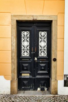 Old and colorful wooden door with iron details in Lisbon, Portugal