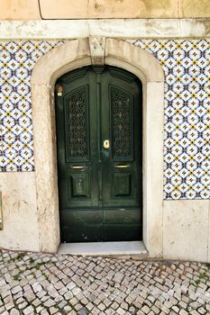 Old and colorful wooden door with iron details in Lisbon, Portugal