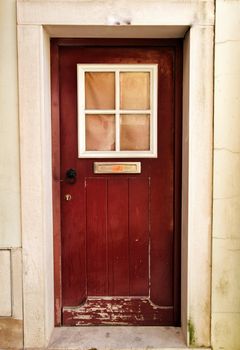 Old and colorful wooden door with iron details in Lisbon, Portugal